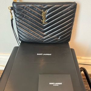 Black YSL clutch/wallet with gold plated YSL logo. medium Size.